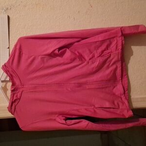 A pink workout zipper up jacket